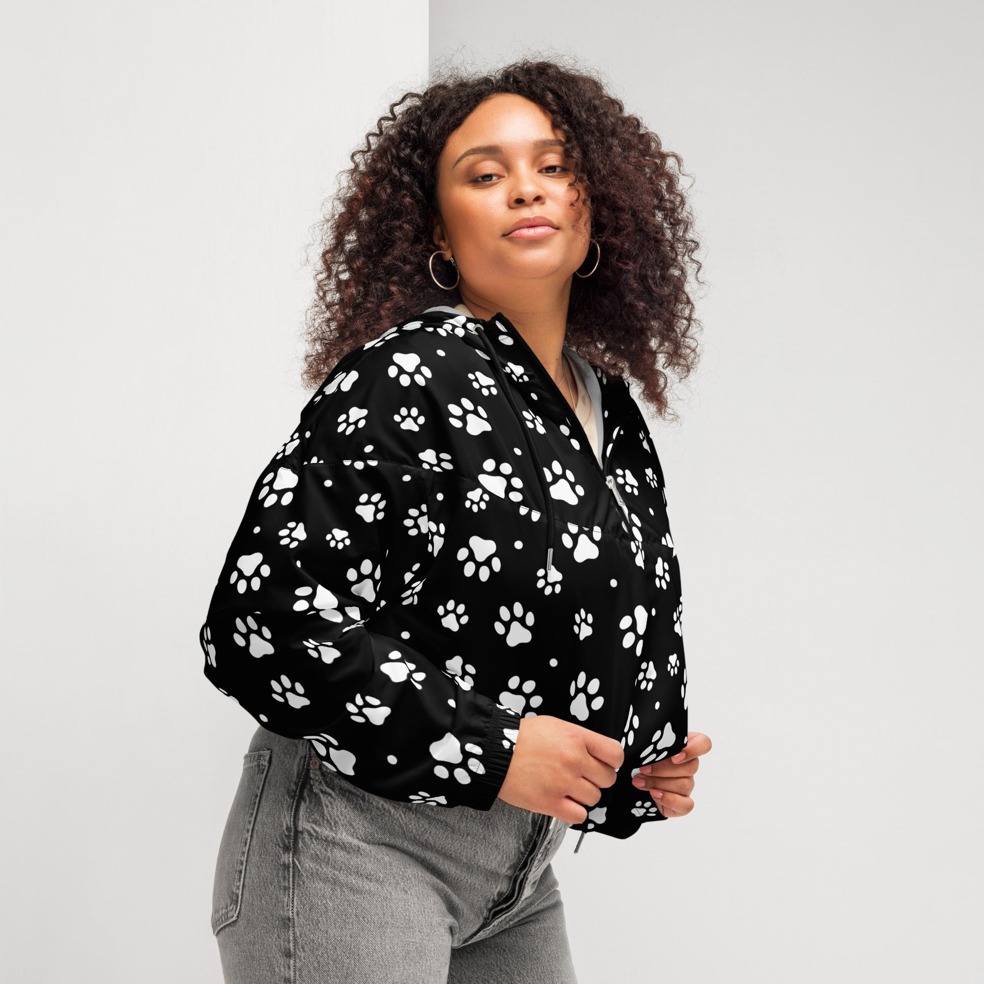 Women’s black bomber jacket with white paw print pattern lightweight water resistant fabric adjustable hood and pockets