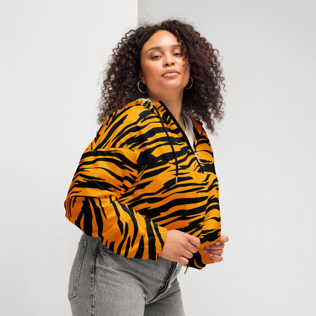 A vibrant orange and black tiger stripe women’s cropped windbreaker with adjustable hood and pockets