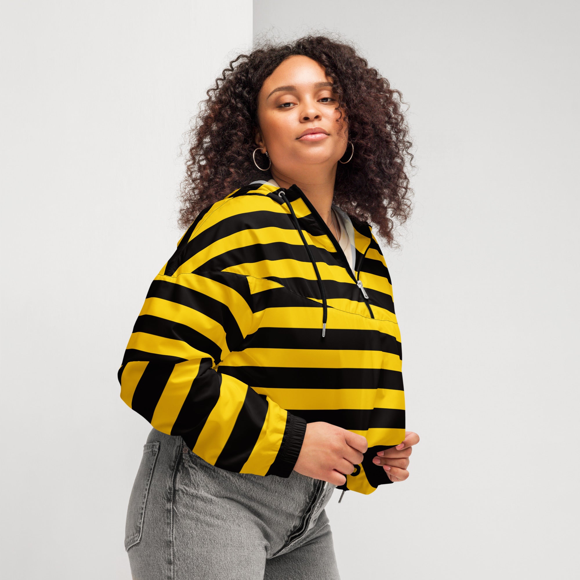 A vibrant yellow and black striped women’s bumblebee stripe cropped bomber jacket with hood and ribbed cuffs