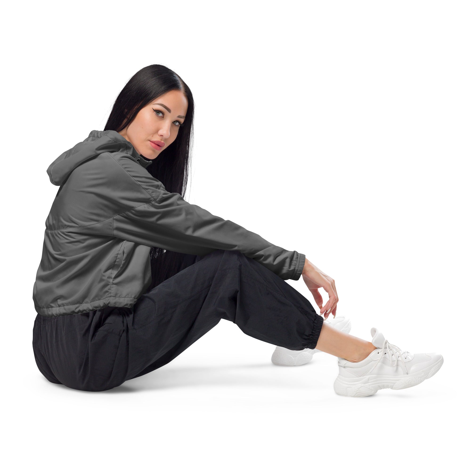 Women’s gray cropped windbreaker with lightweight, water-resistant fabric, adjustable hood, pockets, and subtle seam detailing