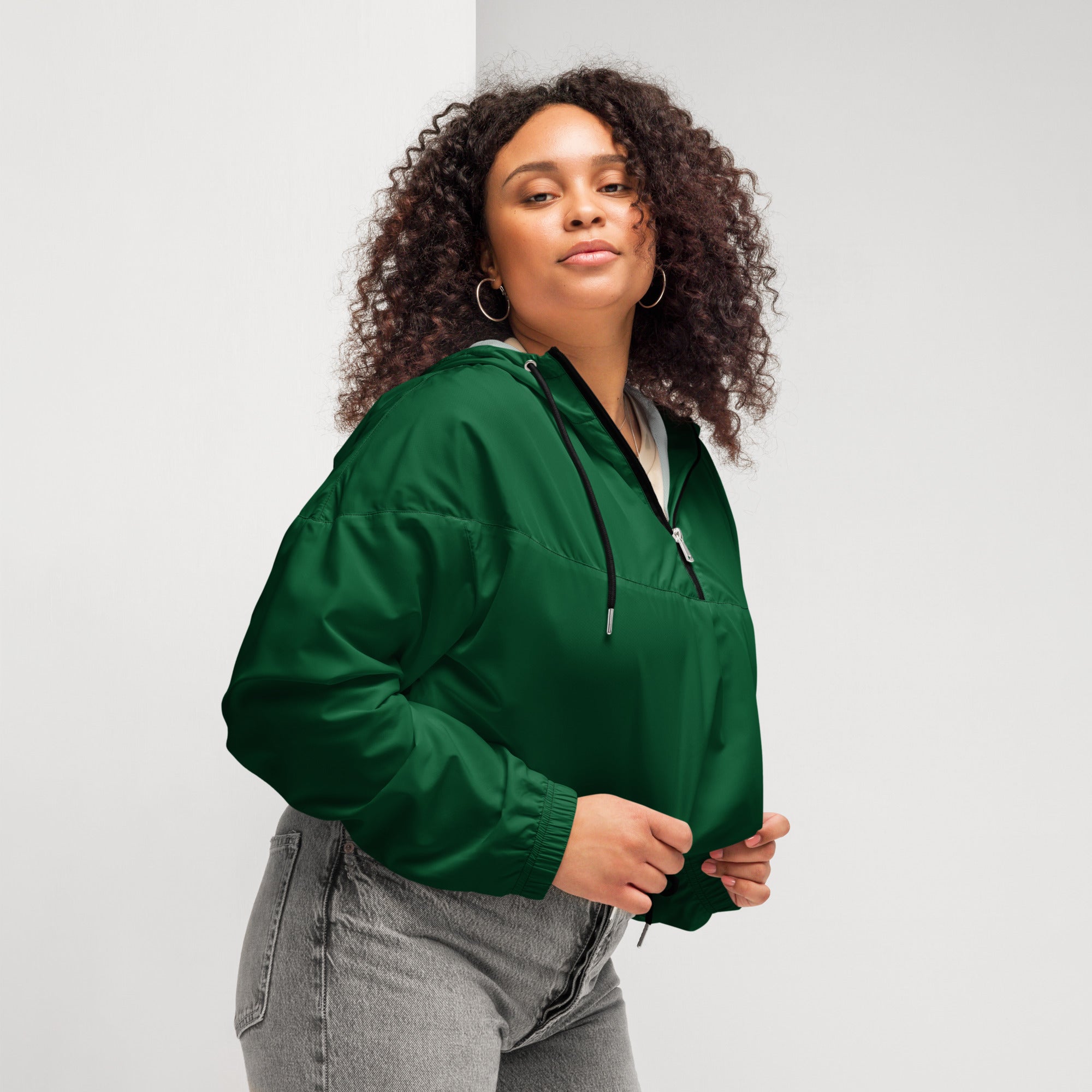 A vibrant green lightweight nylon bomber jacket with half-zip front and drawstring hood for women