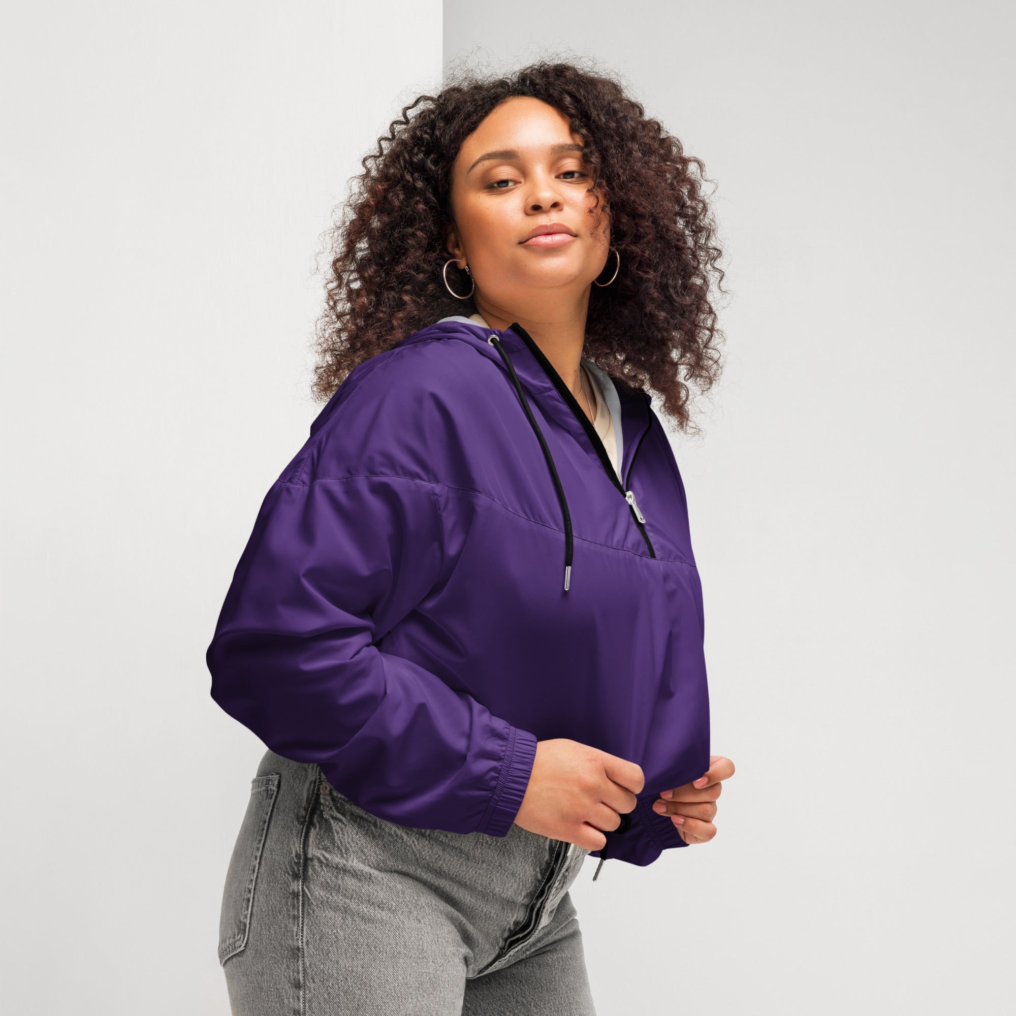 Women’s dark purple cropped nylon anorak jacket with black zipper and adjustable drawstring hood for wind protection