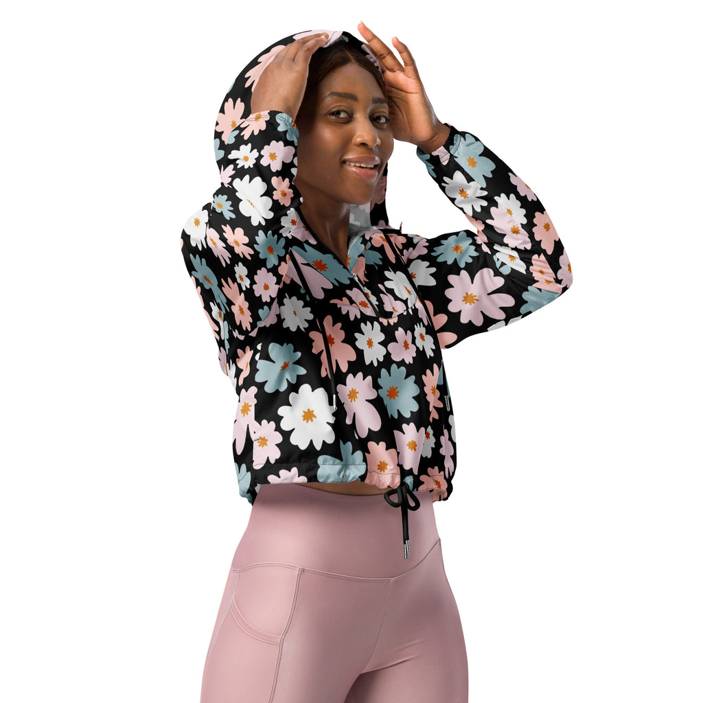 Women’s retro floral cropped windbreaker in black with vibrant pink white and light blue daisy pattern and adjustable hood