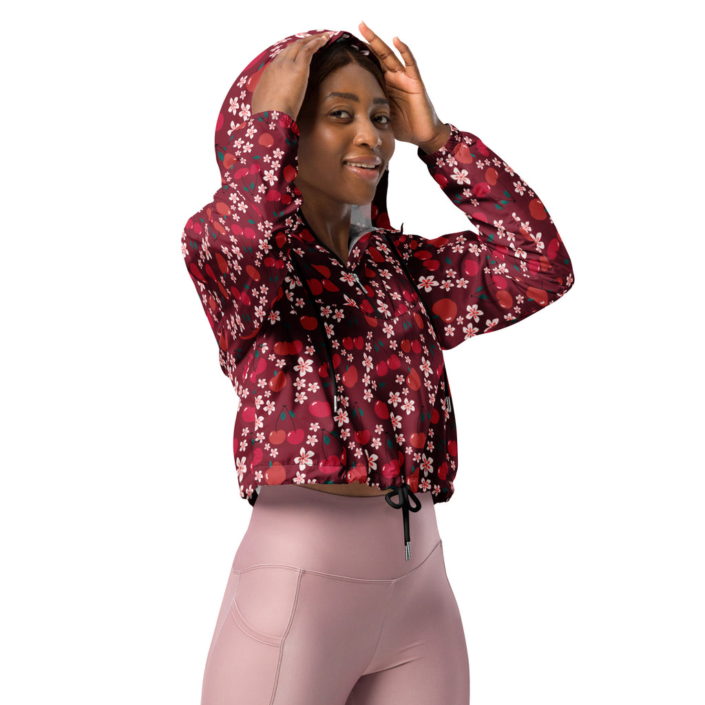 A maroon women’s cherry blossom cropped windbreaker with floral cherry print, drawstring hood, and front zipper