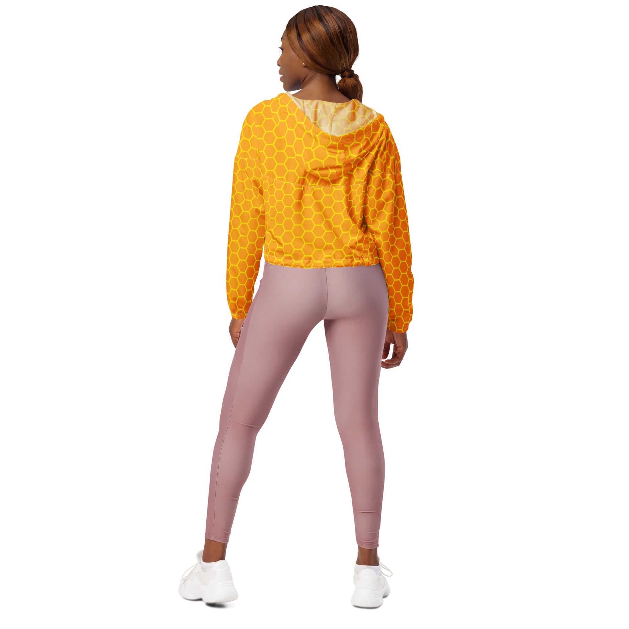 Women’s yellow honeycomb-patterned cropped windbreaker with lightweight water-resistant fabric and light gold lining