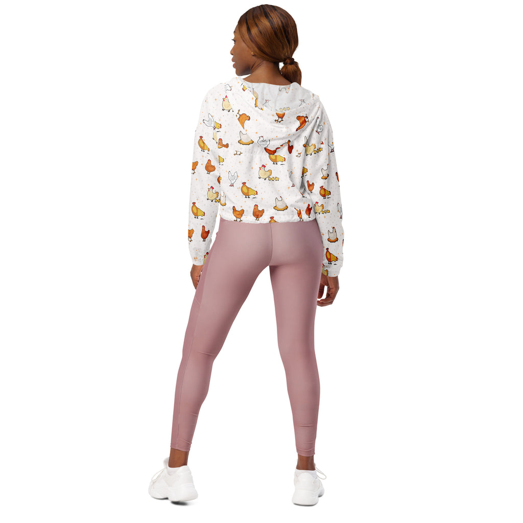 White hoodie with playful chicken print paired with pink leggings in a lightweight water resistant women’s windbreaker set