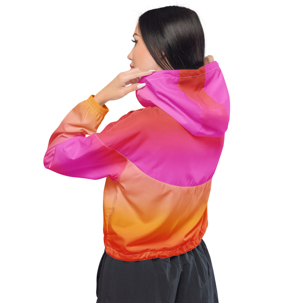 Women’s sunset ombre cropped windbreaker jacket in vibrant pink to orange nylon with elasticated adjustable hood and pockets