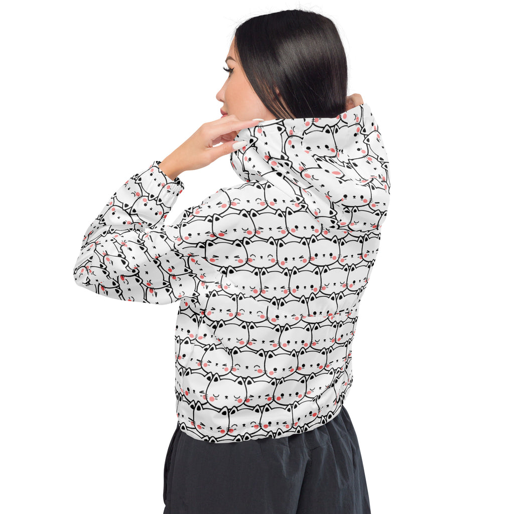 White hooded women’s cropped windbreaker with black outlined cartoon cats and pink blush cheeks pattern