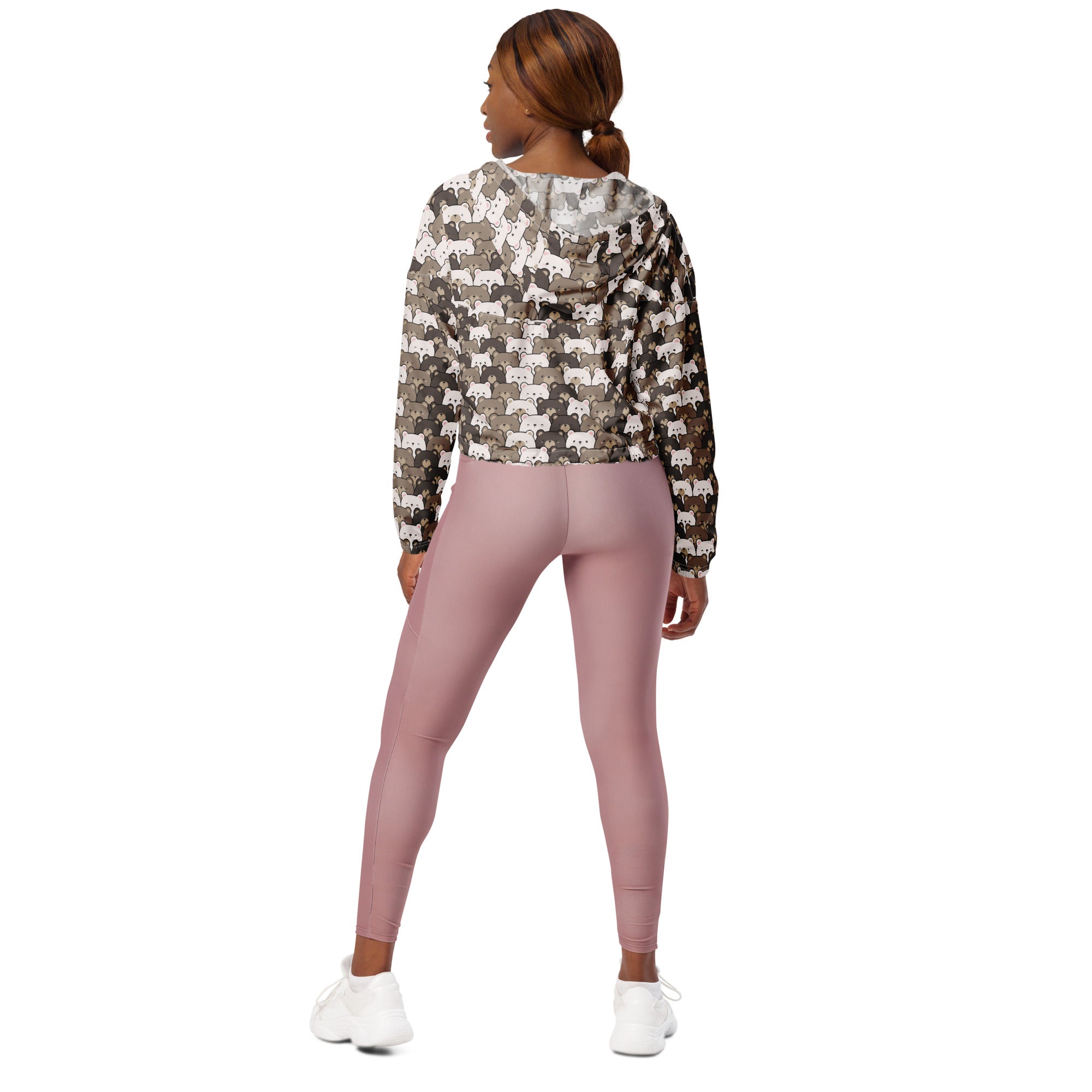 A woman wears a lightweight water-resistant women’s bear face cropped windbreaker with cartoon fox pattern