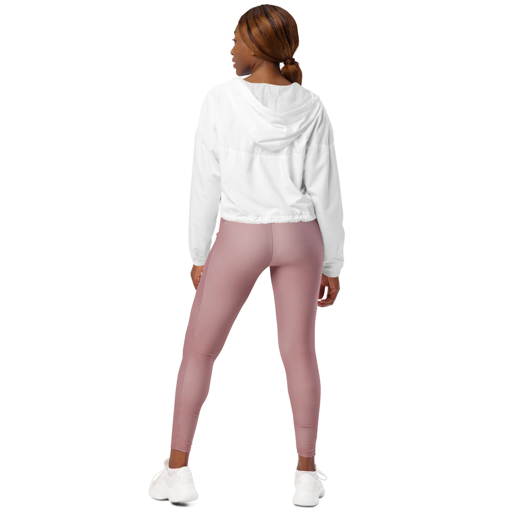 A woman wears a women’s white cropped windbreaker lightweight water resistant jacket with adjustable hood and pockets