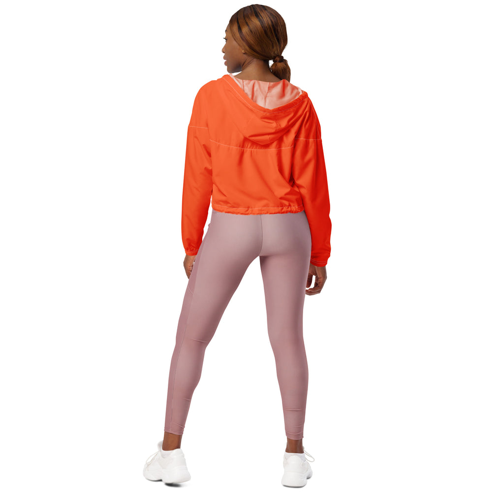 Women’s bright orange cropped windbreaker with light pink lining elastic cuffs adjustable hood and pockets