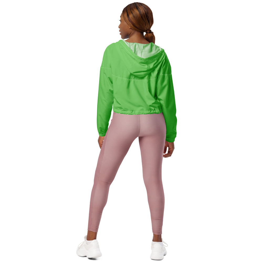 Women’s green cropped windbreaker lightweight water resistant jacket with adjustable hood worn over mauve leggings
