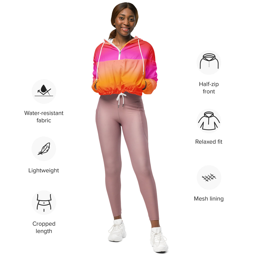 Women’s sunset ombre cropped windbreaker in vibrant pink to orange gradient with half-zip front and mesh lining paired with mauve leggings
