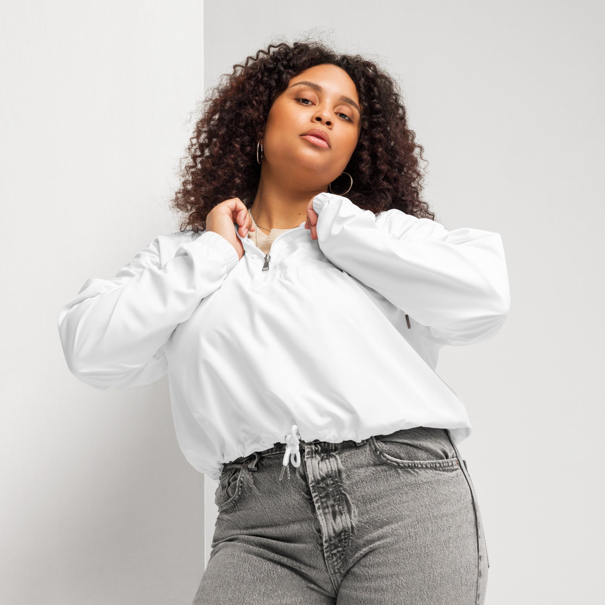 White cropped bomber jacket with half-zip front and drawstring waist in a lightweight water resistant fabric