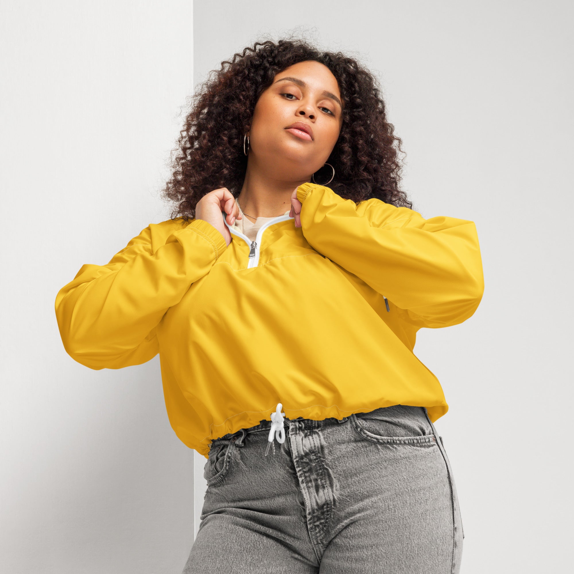 Women’s yellow cropped lightweight nylon bomber jacket with white zipper and adjustable drawstring waist
