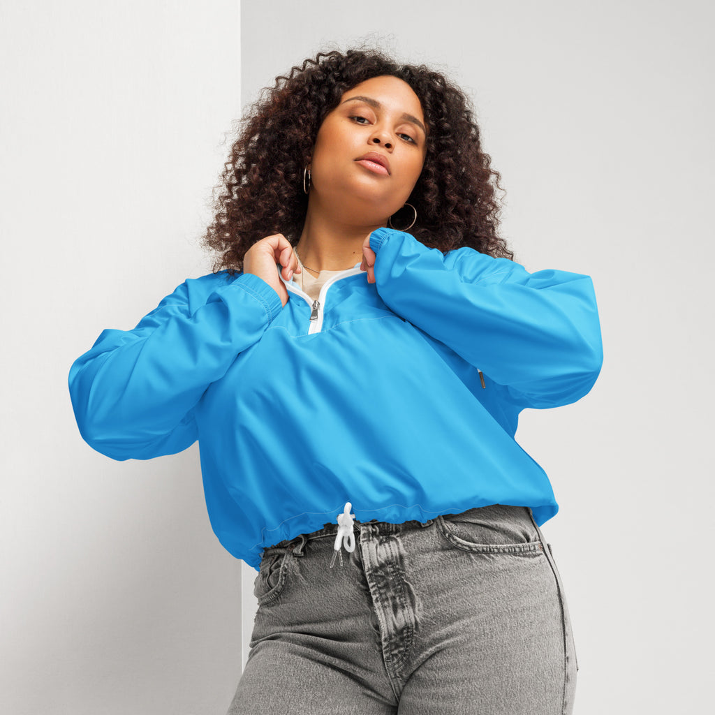 Bright blue lightweight nylon women’s cropped windbreaker with white zipper and adjustable drawstring waist