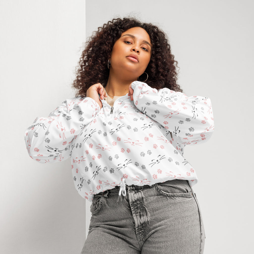 White women’s cat paw and whisker cropped bomber jacket with pink gray and black playful patterns and adjustable hood