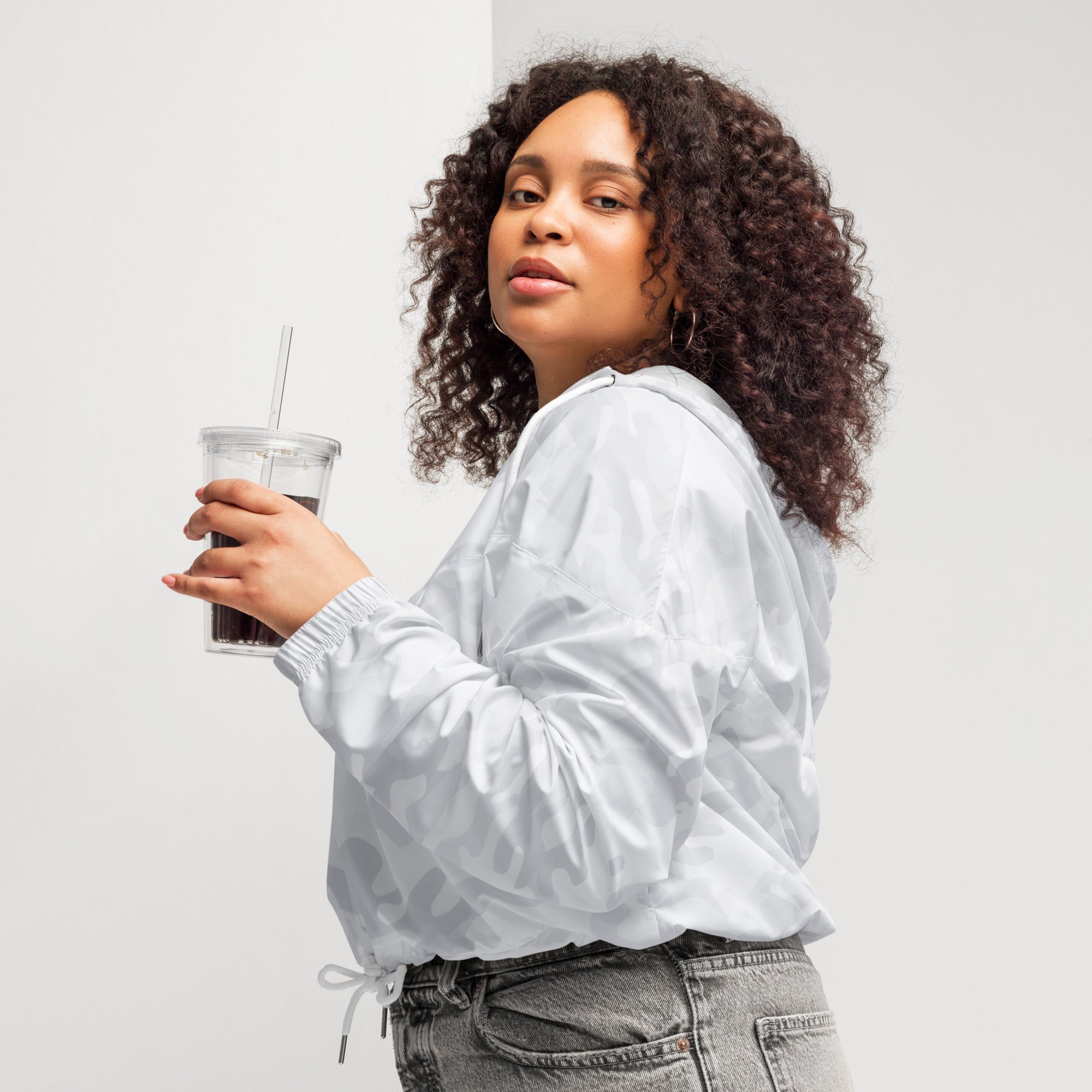 White bomber jacket with subtle geometric pattern and drawstring waistband for lightweight wind resistance