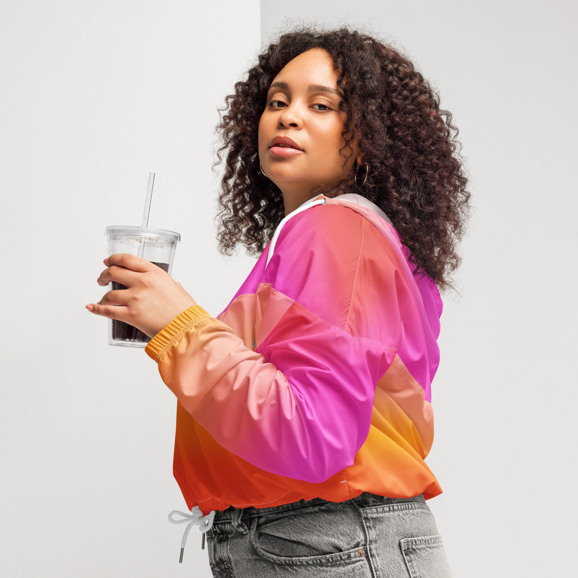 Women’s sunset ombre cropped windbreaker jacket in vibrant pink orange and magenta nylon with adjustable hood and pockets