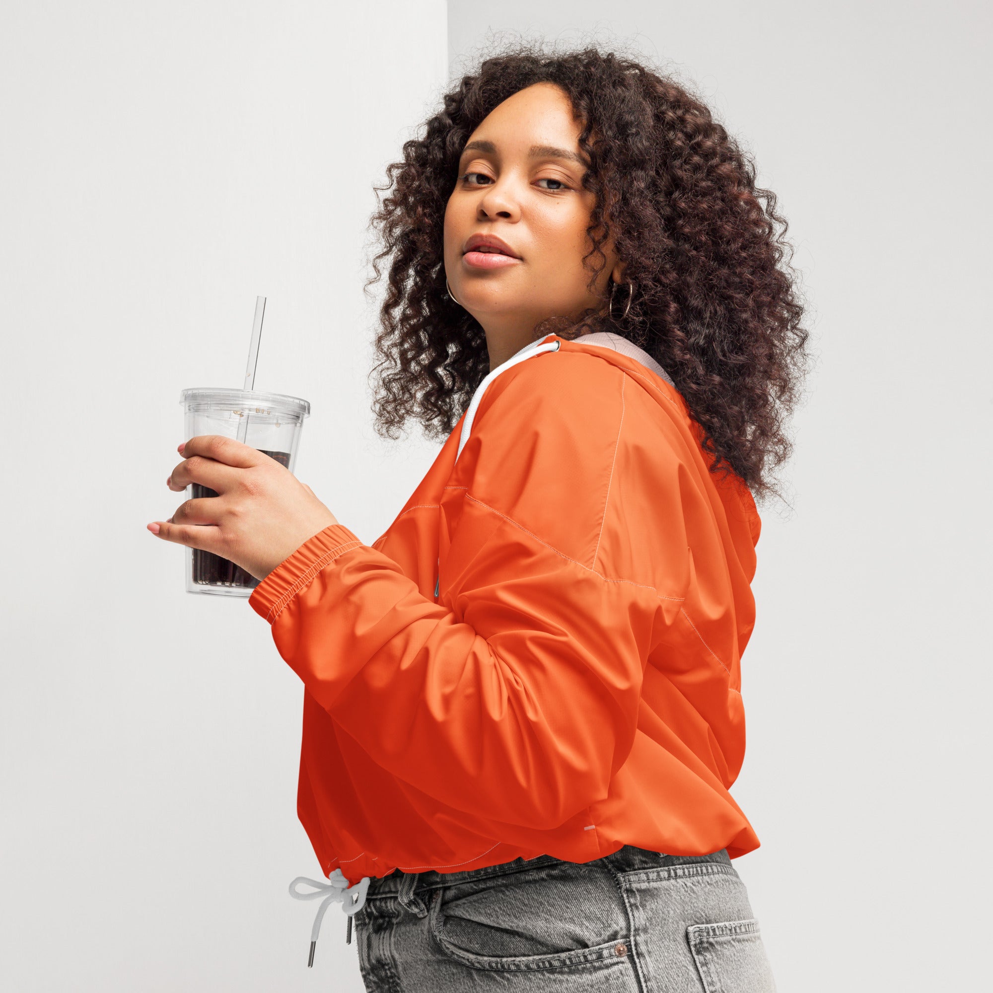 Women’s bright orange cropped bomber jacket with white drawstring hood lining lightweight and water resistant
