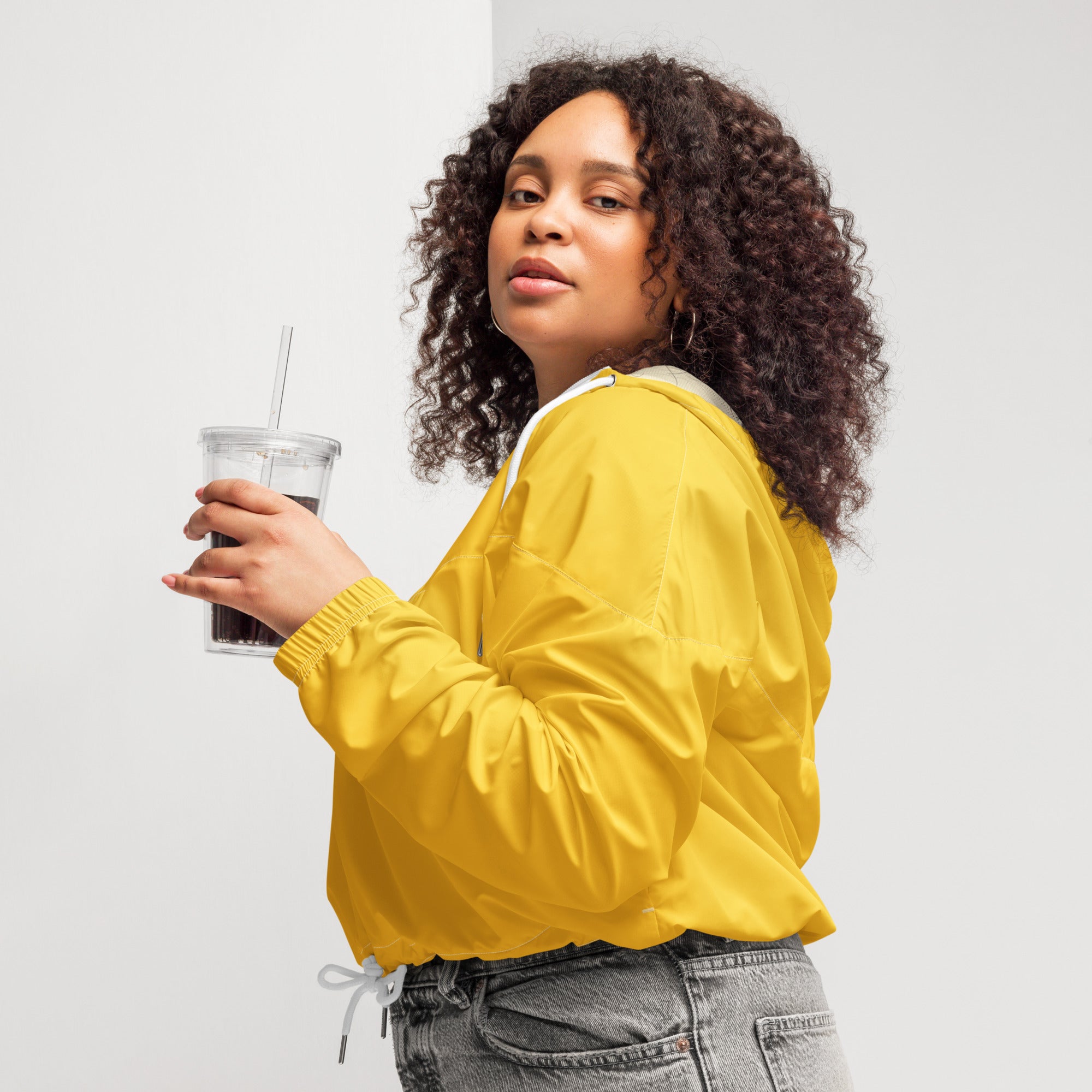 Women’s yellow cropped windbreaker with white drawstring and hood lining lightweight water resistant jacket with pockets