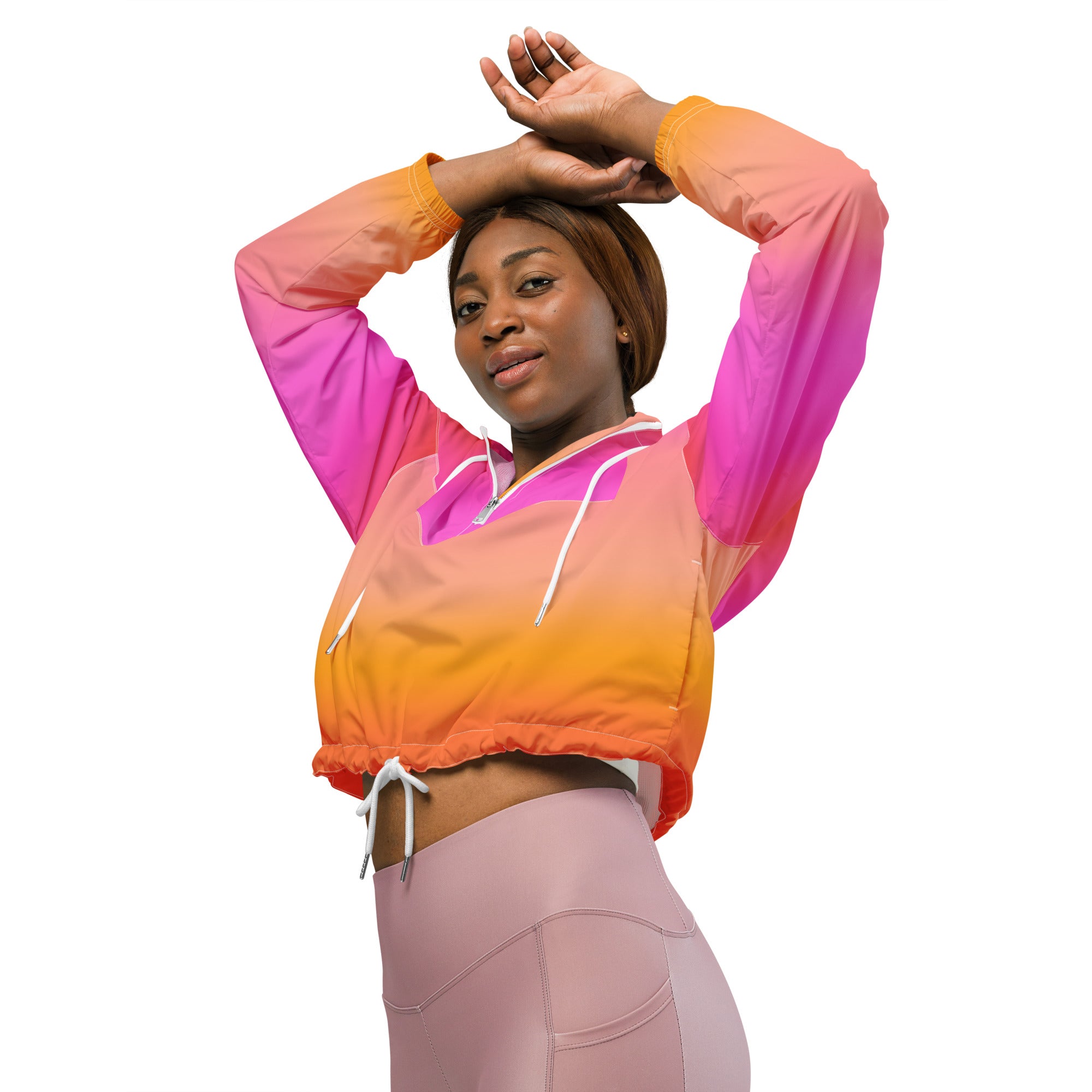 Women’s lightweight water resistant cropped windbreaker hoodie with pink to orange ombre gradient and white drawstrings