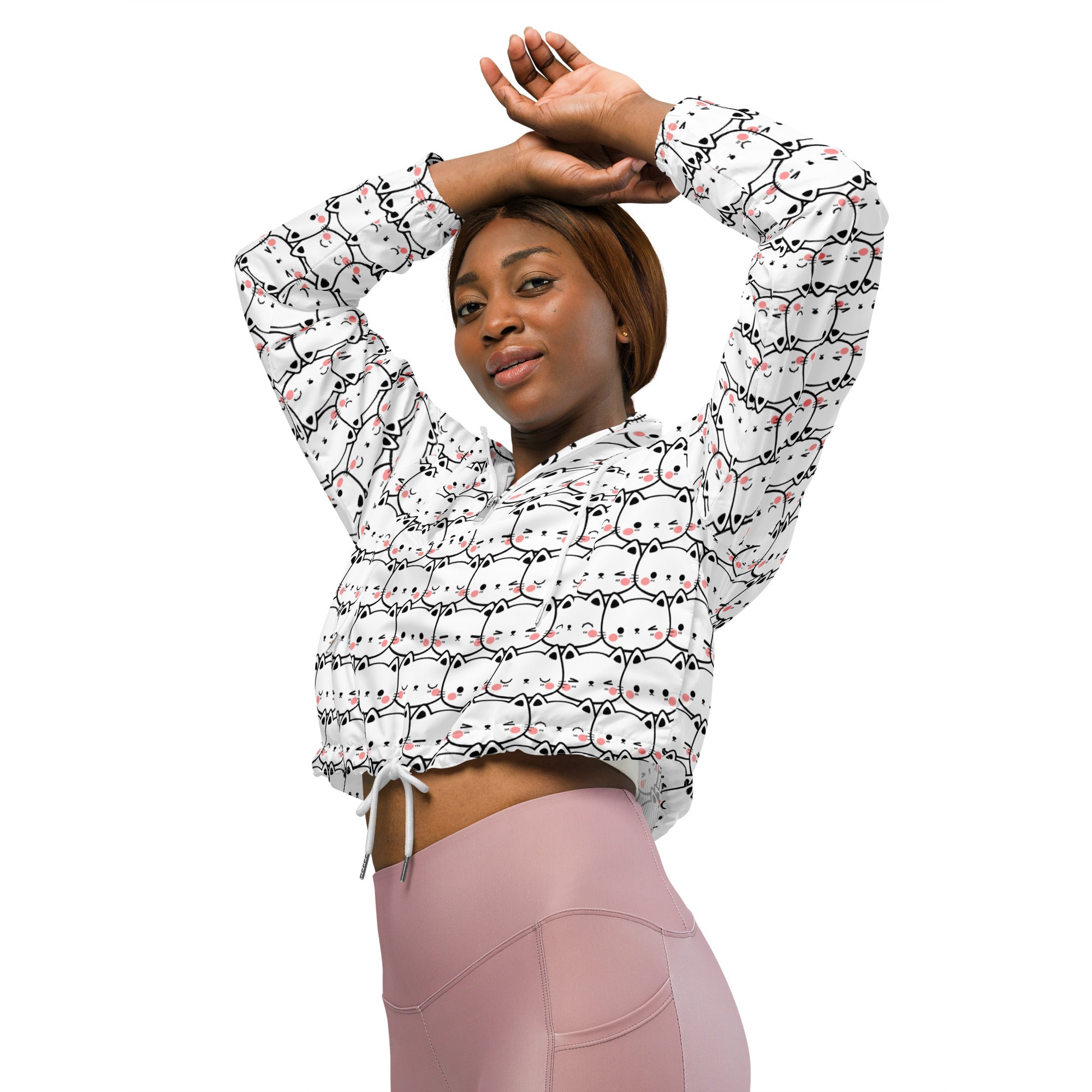 White cropped windbreaker featuring playful black-outlined cartoon cats with pink blush cheeks and adjustable hood