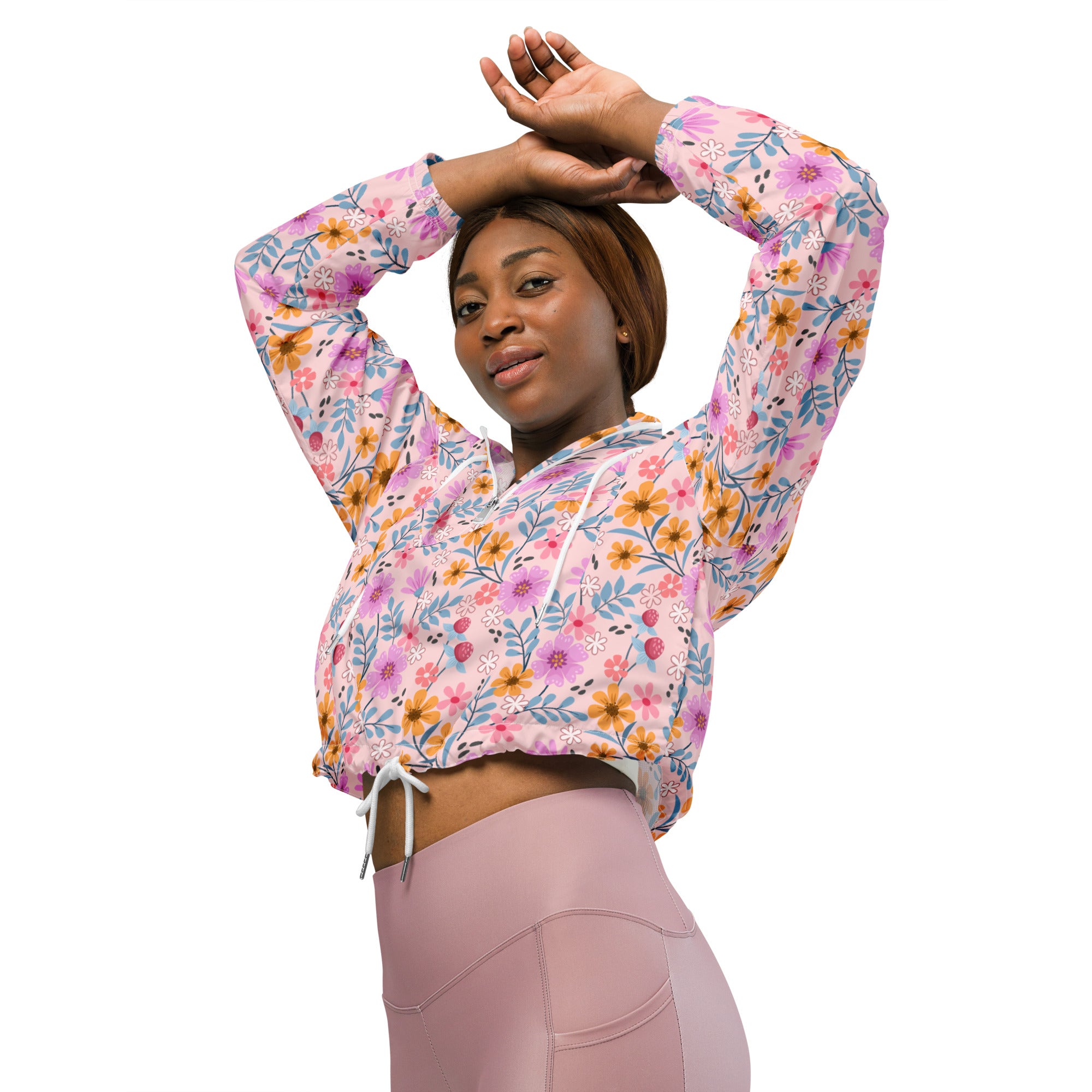 Women’s pink floral cropped windbreaker hoodie with long sleeves and adjustable drawstring hood made from lightweight fabric