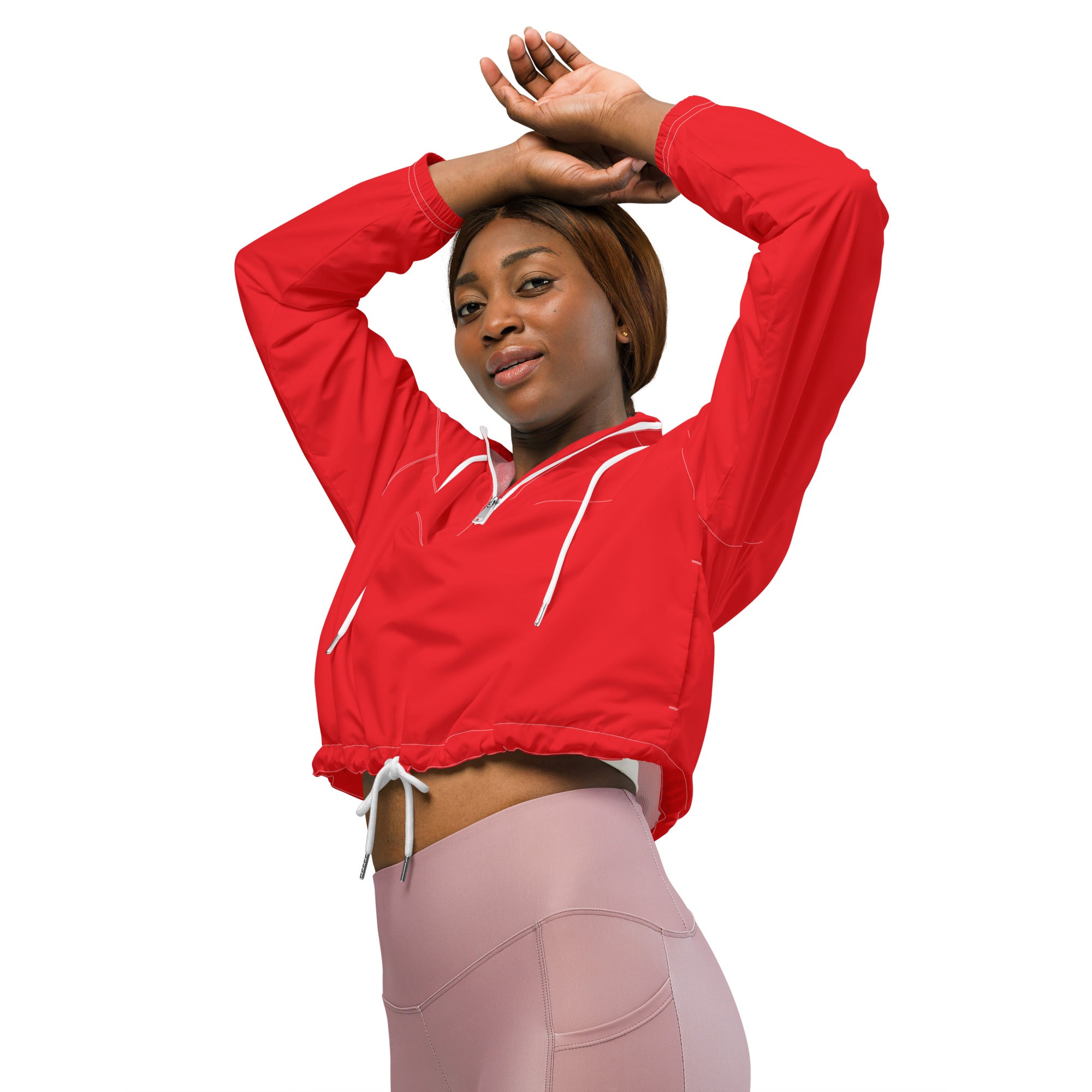 Woman’s red cropped lightweight windbreaker jacket with white zipper and drawstring details for athletic use