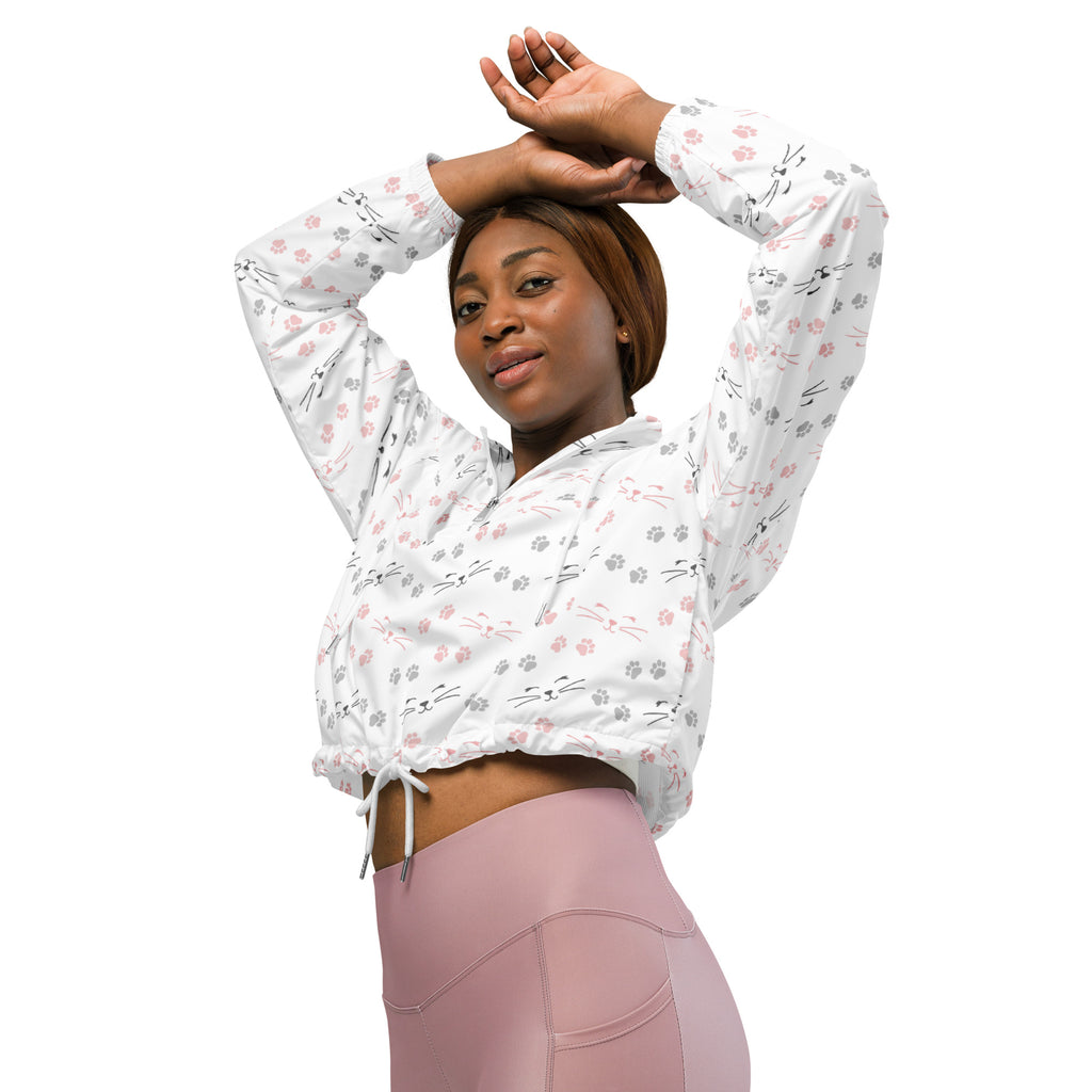 White cropped hoodie with pink and gray cat faces and paw prints featuring a drawstring waist for adjustable fit