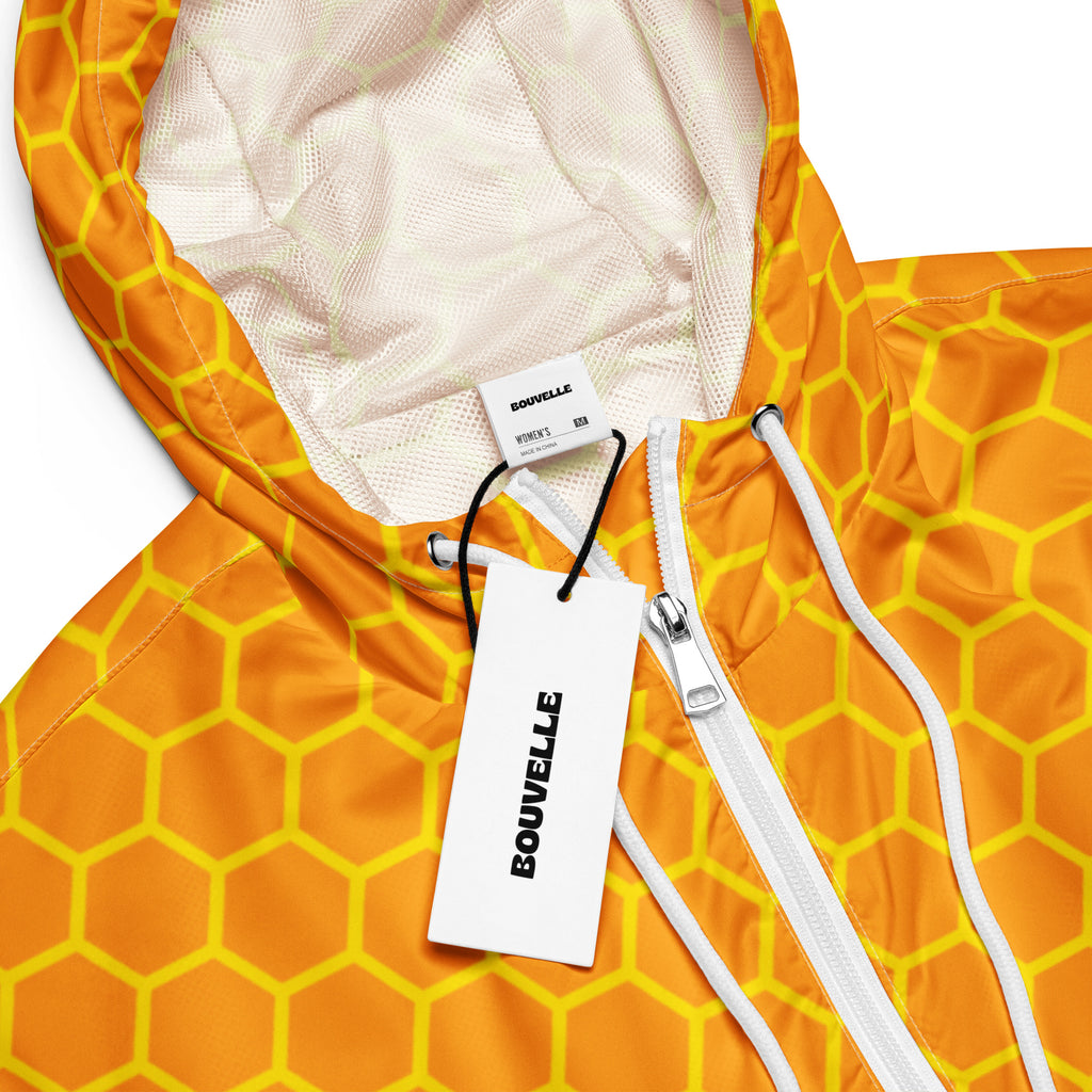 Women’s orange and yellow honeycomb patterned cropped windbreaker hooded jacket with white zipper and drawstrings