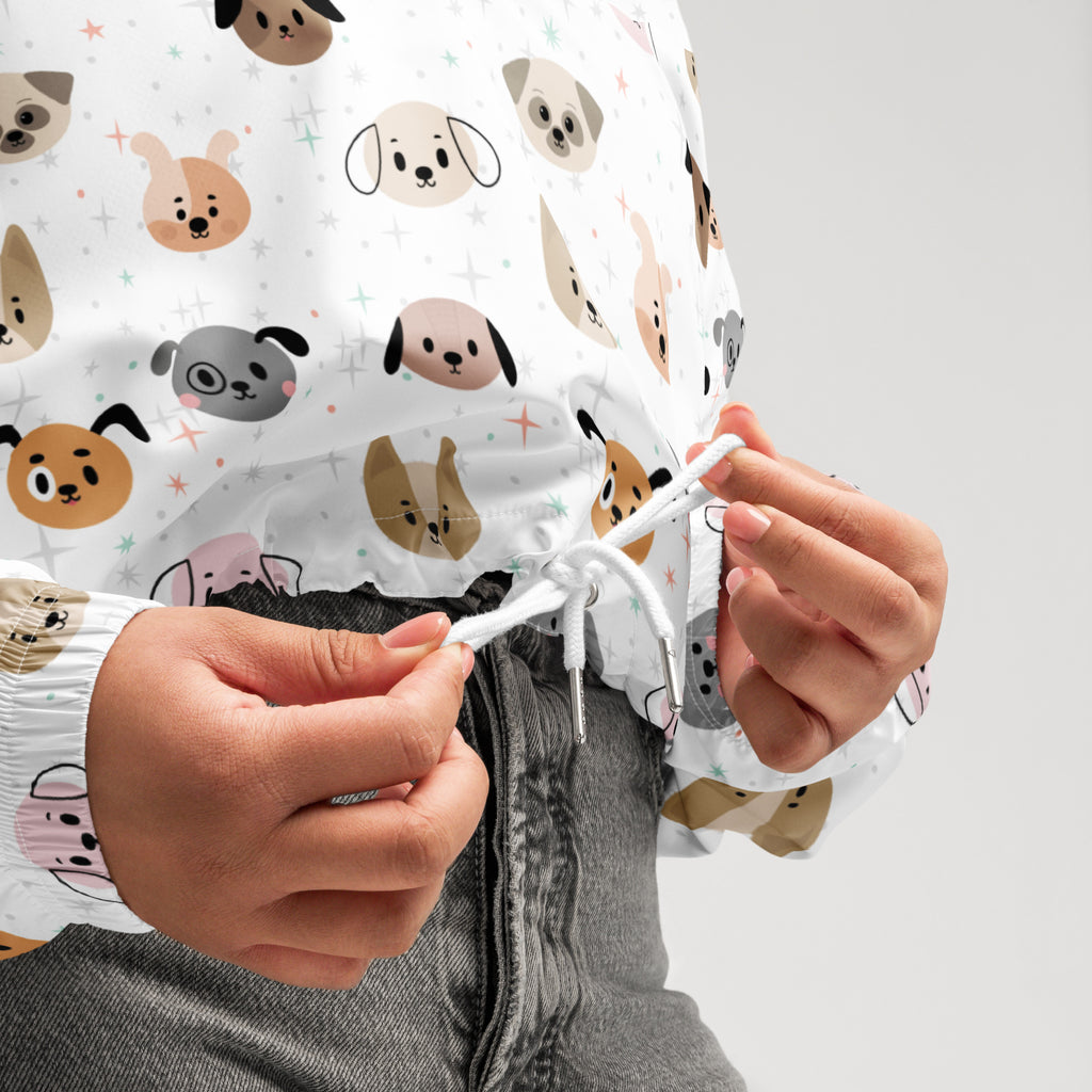 Women’s white cropped windbreaker with adjustable hood featuring colorful cartoon dog faces pattern