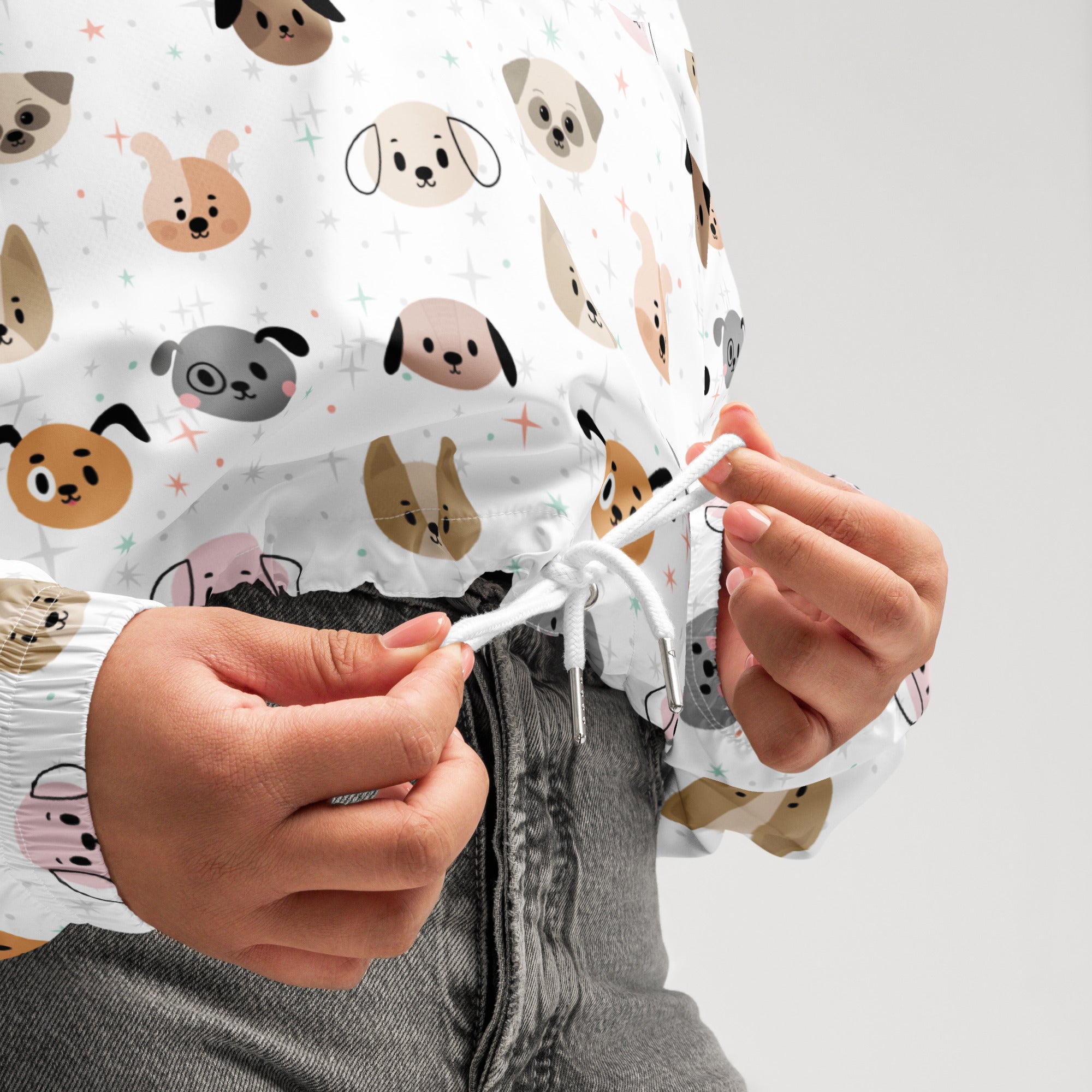 Women’s white cropped windbreaker with adjustable hood featuring colorful cartoon dog faces pattern