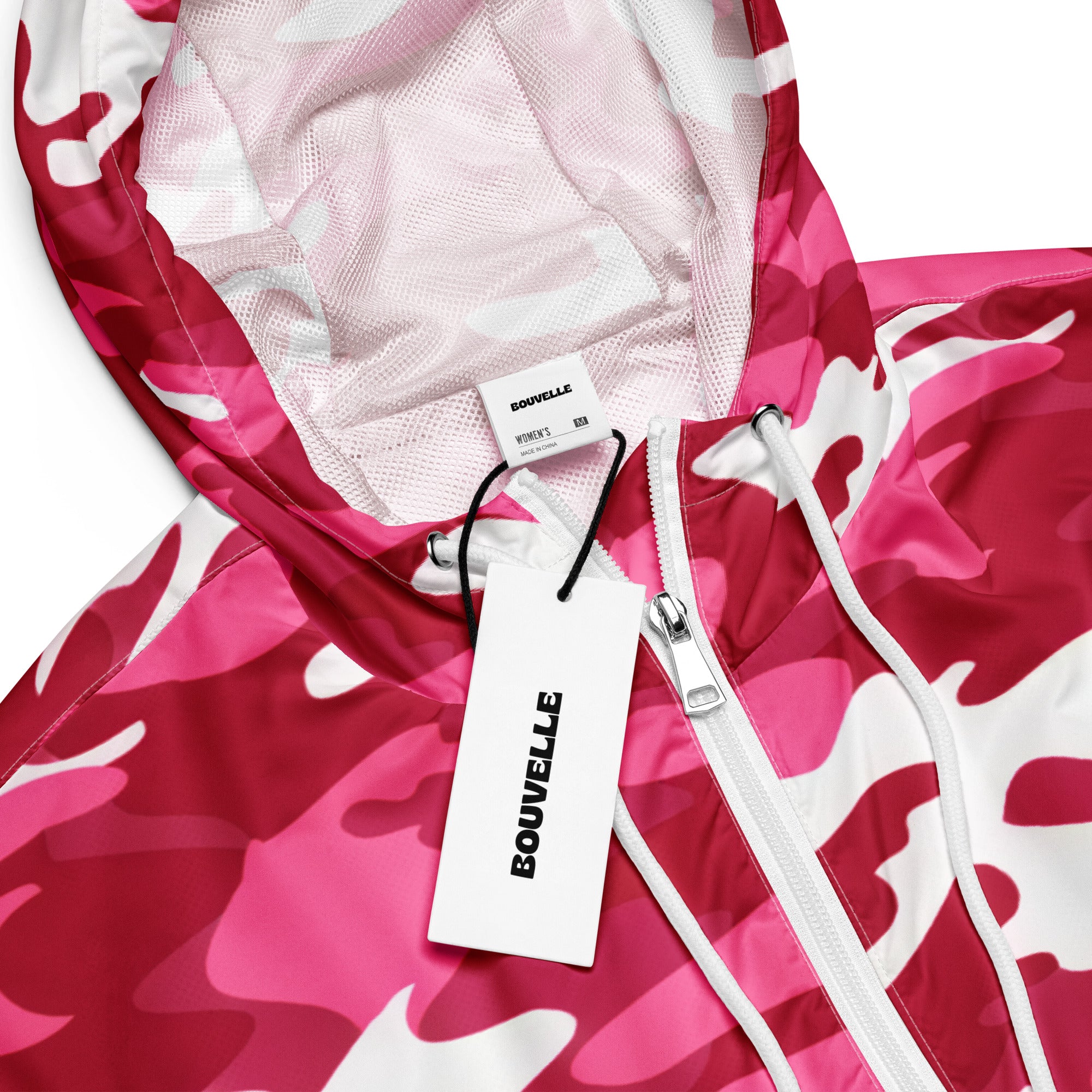 A vibrant pink and white camouflage patterned bouvelle cropped windbreaker jacket with mesh-lined hood and white zipper accents