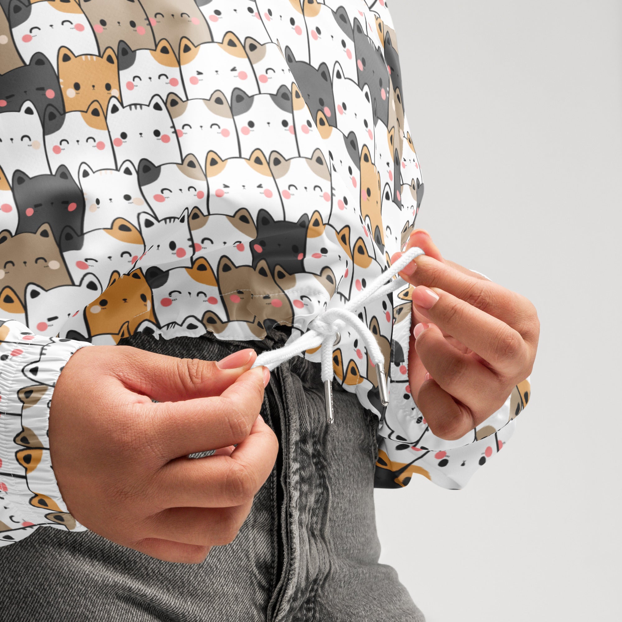 Women’s kawaii cat cropped white windbreaker featuring playful cartoon cats with adjustable hood and pockets