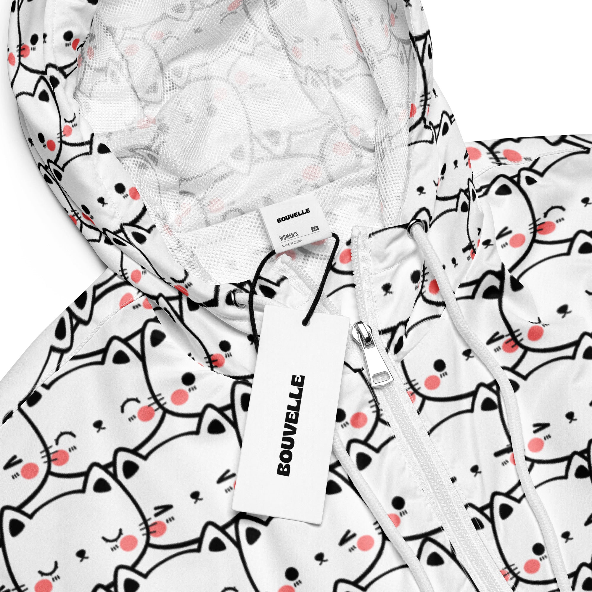 White hooded women’s cropped windbreaker with playful black outlined cartoon cats and pink blush marks pattern