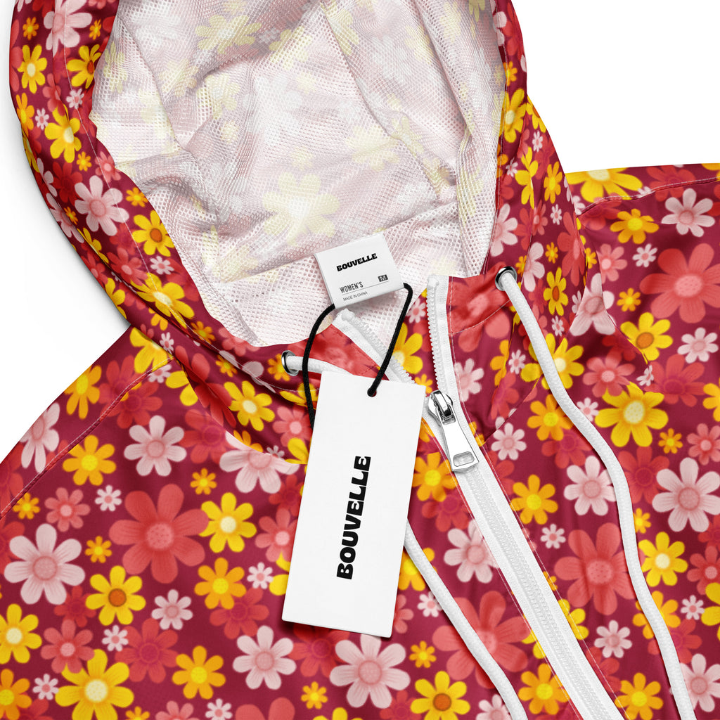 Women’s red floral cropped windbreaker with vibrant red yellow pink pattern, white zipper, adjustable hood, and pockets
