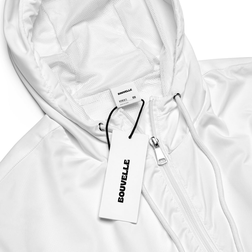 Women’s white cropped windbreaker with shiny nylon exterior mesh lining adjustable hood and pockets seen from back