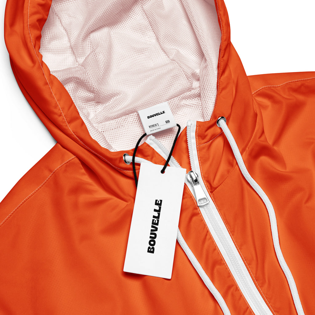 Women’s orange cropped bouvvelle windbreaker with white zipper drawstrings lightweight water resistant jacket