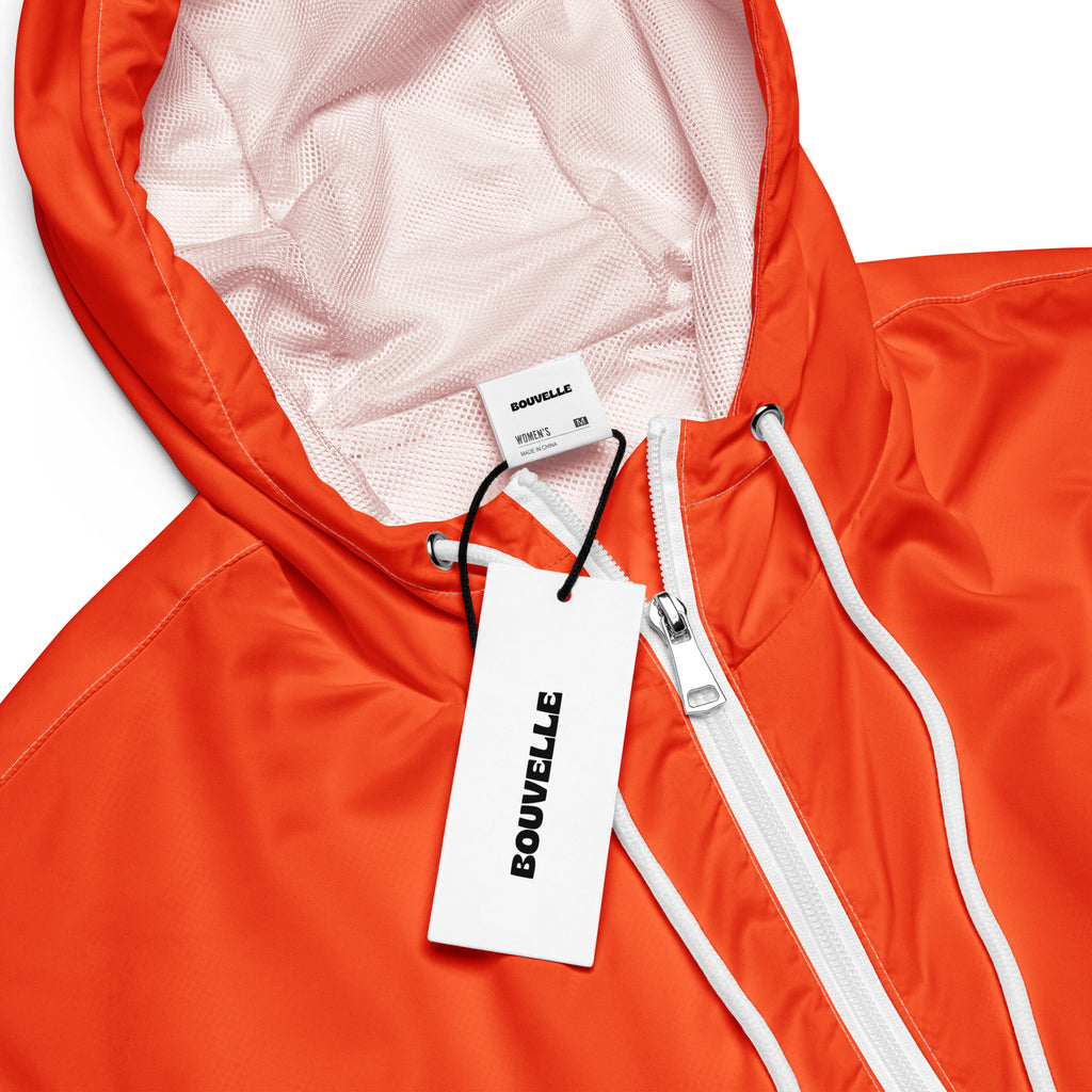 Women’s bright orange cropped bouvvelle windbreaker with white zipper mesh-lined adjustable hood and pockets