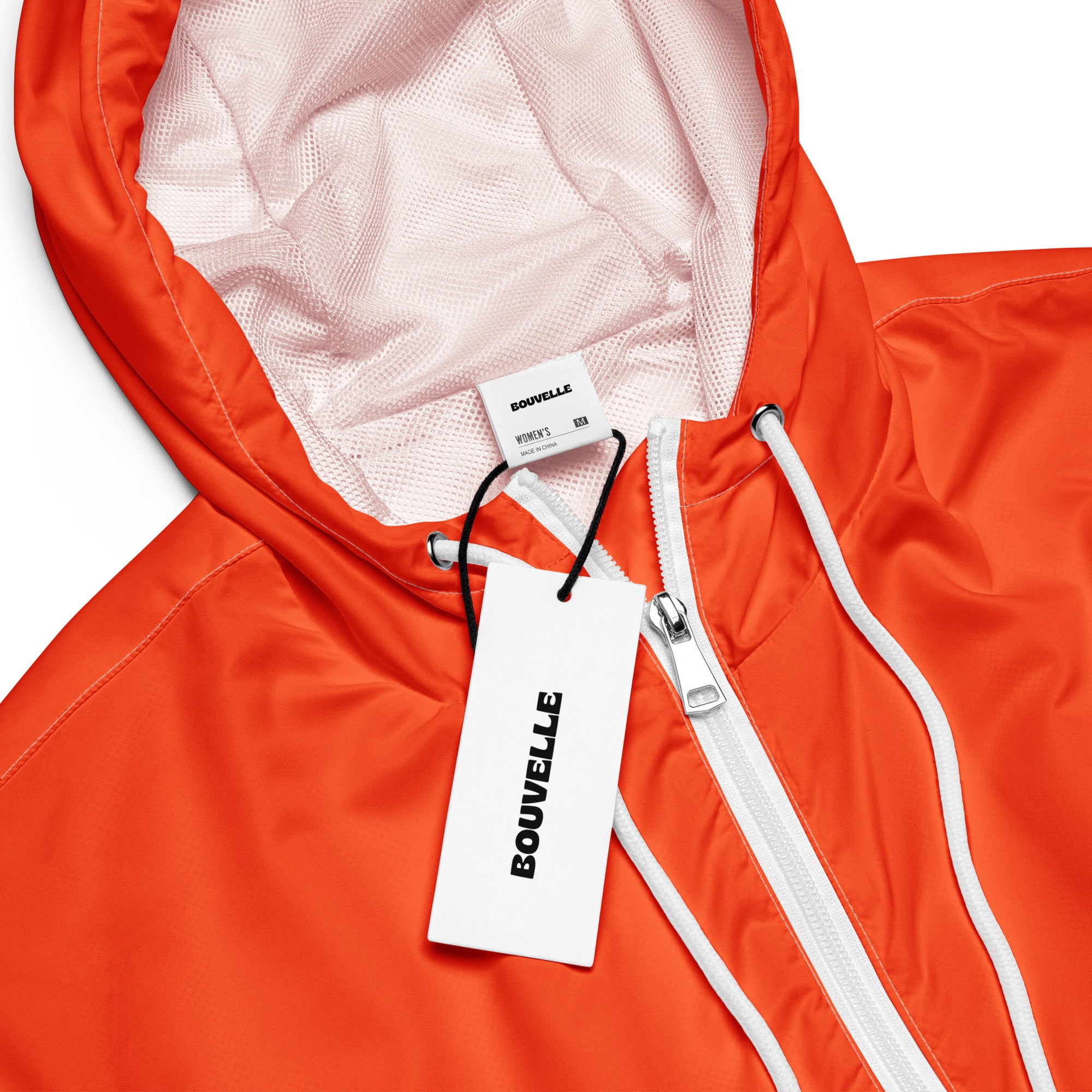 Women’s bright orange cropped bouvvelle windbreaker with white zipper mesh-lined adjustable hood and pockets