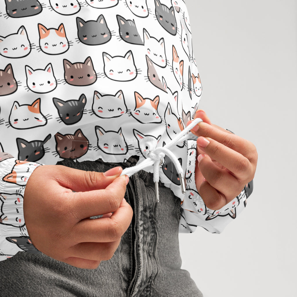 White women’s cat cropped windbreaker with playful gray black and orange cartoon cat pattern and adjustable hood and pockets