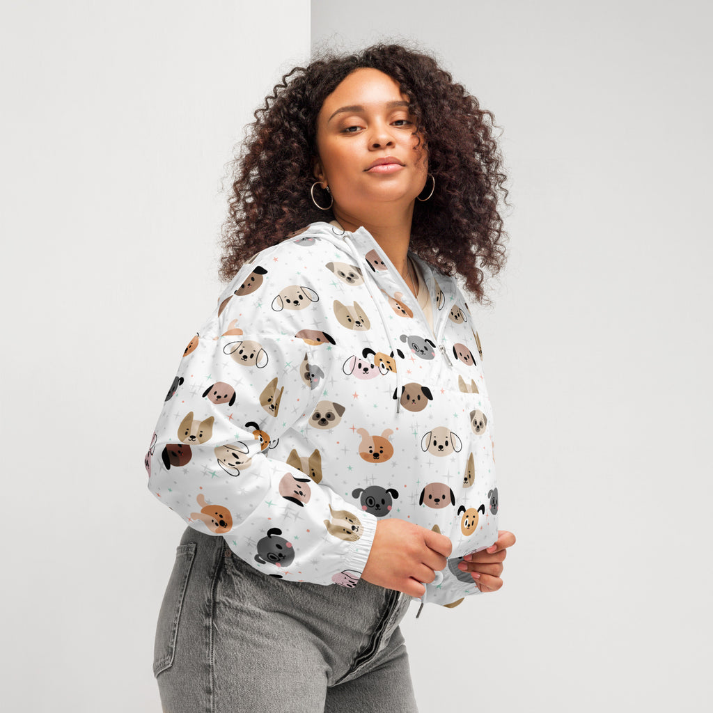 White cropped hoodie with playful cartoon dogs pattern in various colors featuring adjustable hood and pockets