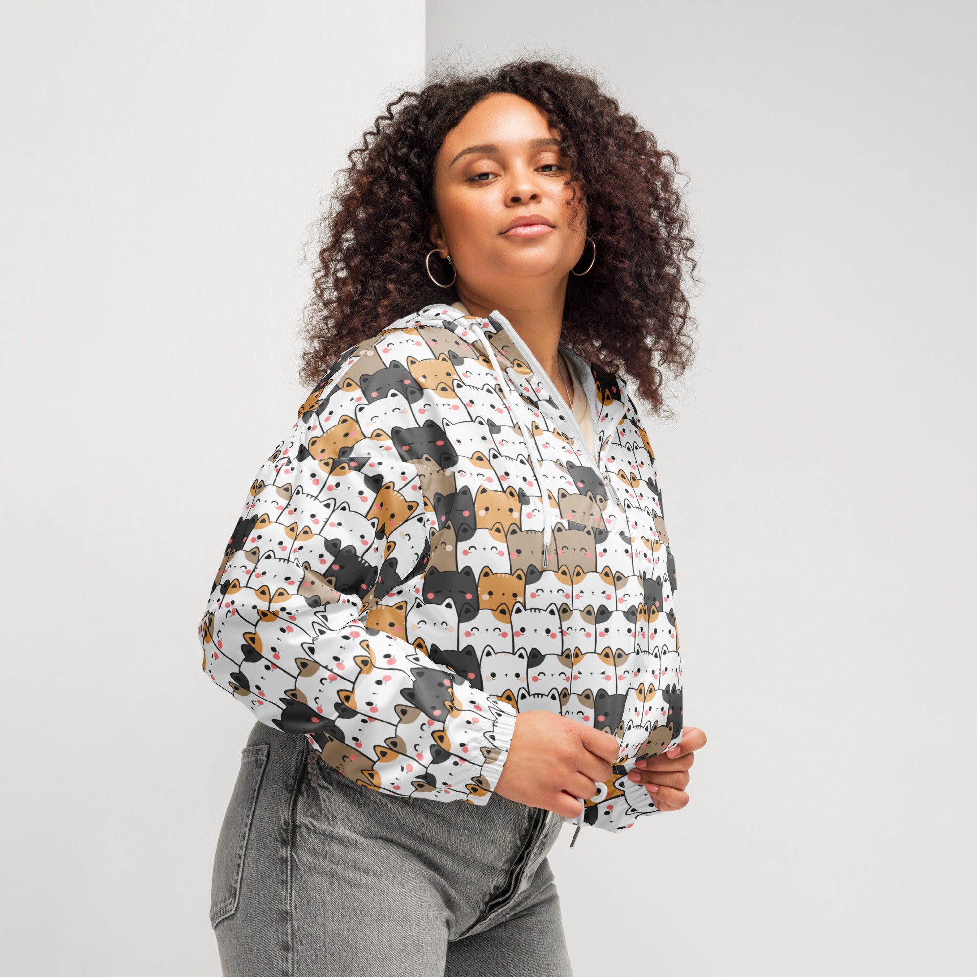 White cropped hoodie with playful multicolor cartoon cats in lightweight water resistant fabric with adjustable hood and pockets