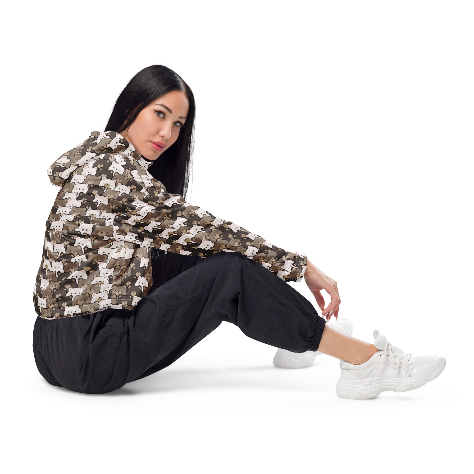A woman wearing a lightweight water resistant women’s bear face cropped windbreaker with white cat faces and hood