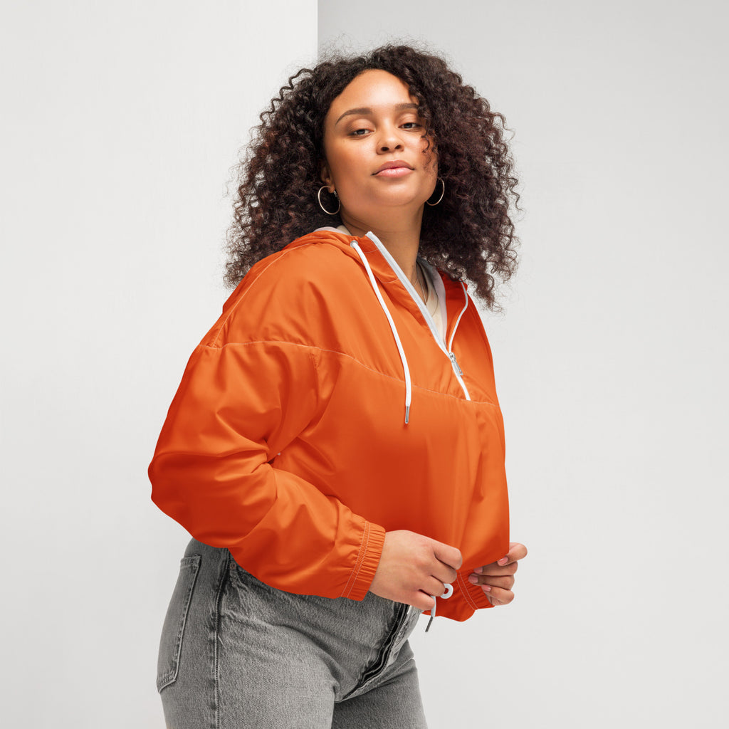 Women’s vibrant orange lightweight cropped windbreaker with hood white drawstrings zipper accents and pockets