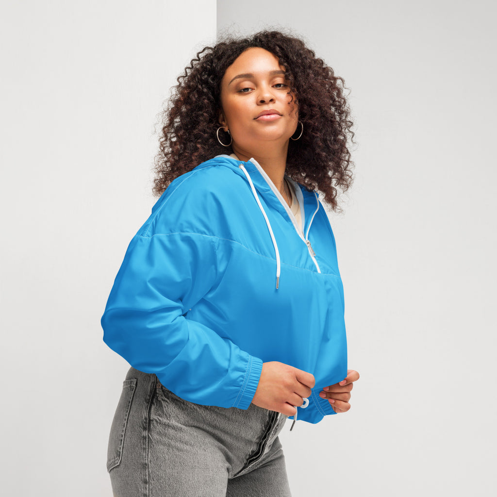 Women’s sky blue cropped windbreaker made of lightweight nylon with hood white drawstrings and zipper accents