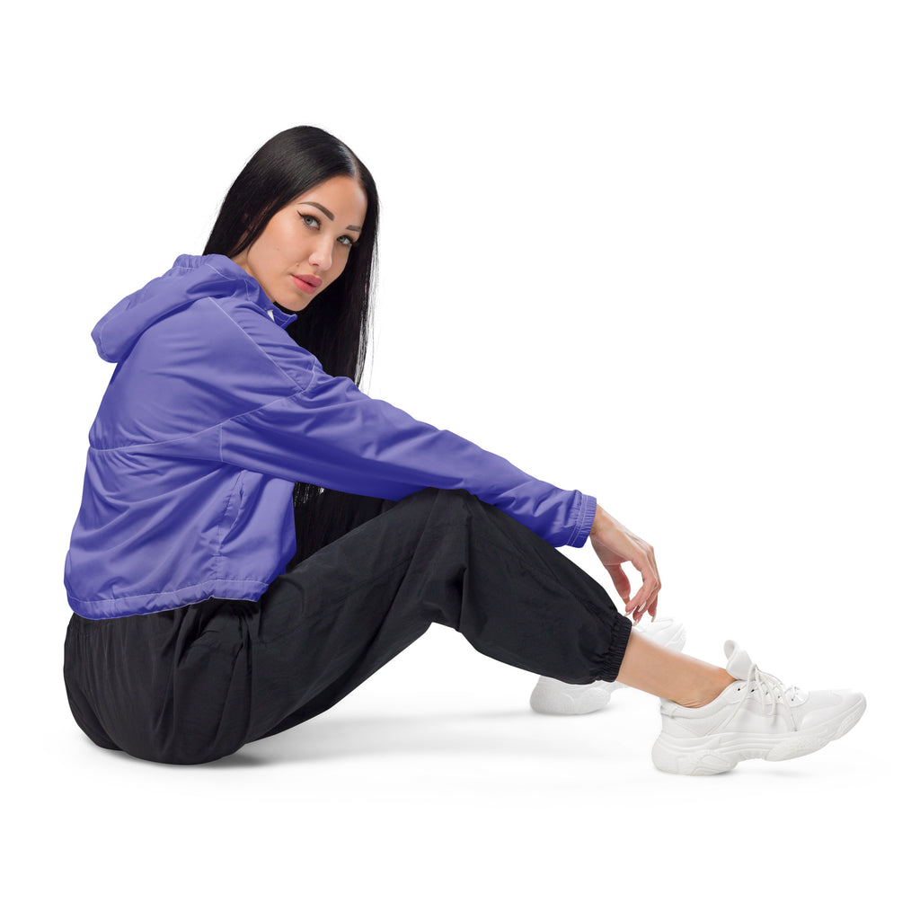 Vibrant purple cropped women’s windbreaker with lightweight fabric, adjustable hood, pockets, and subtle seam detailing