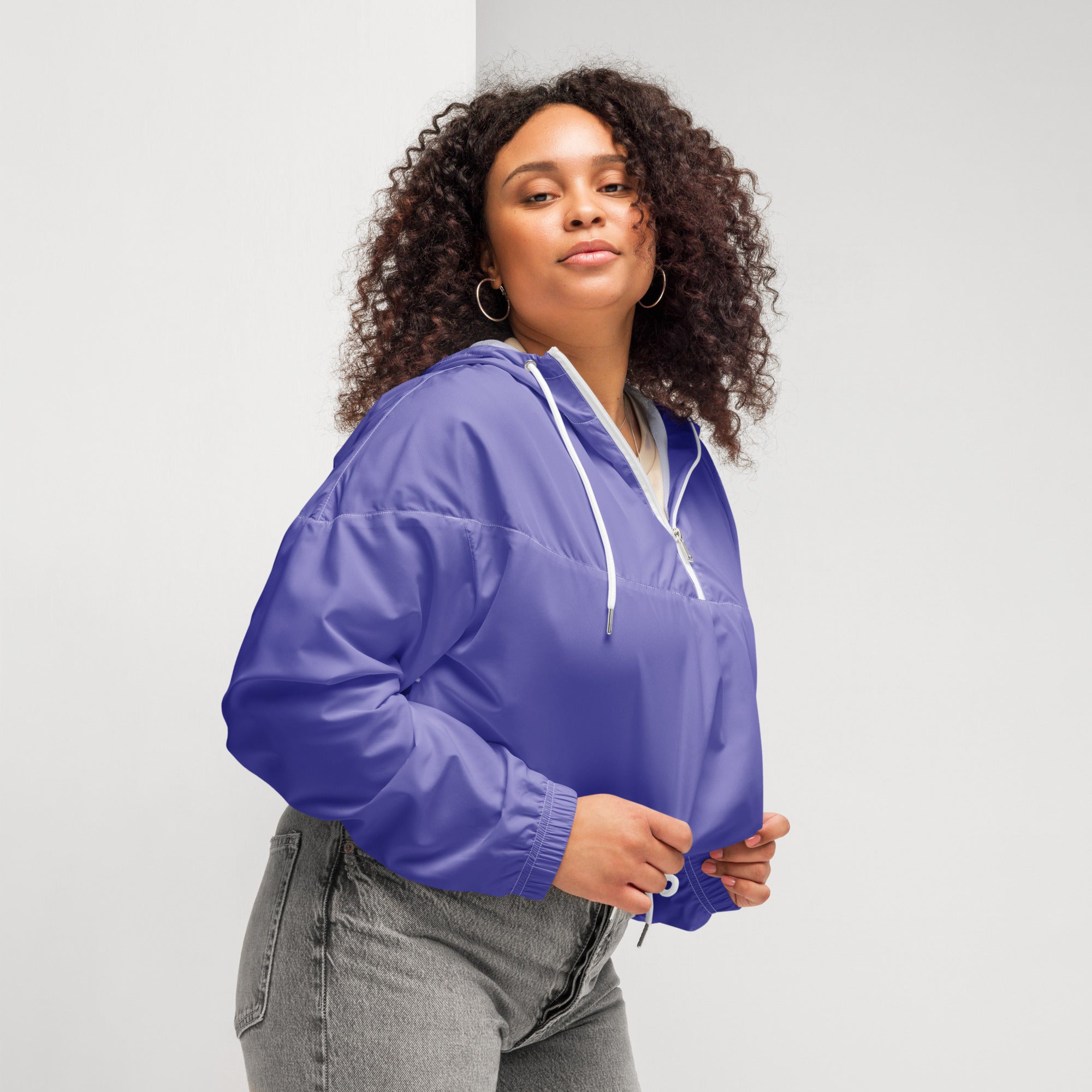 Vibrant purple lightweight women’s cropped windbreaker with adjustable hood white drawstrings and front zipper pockets
