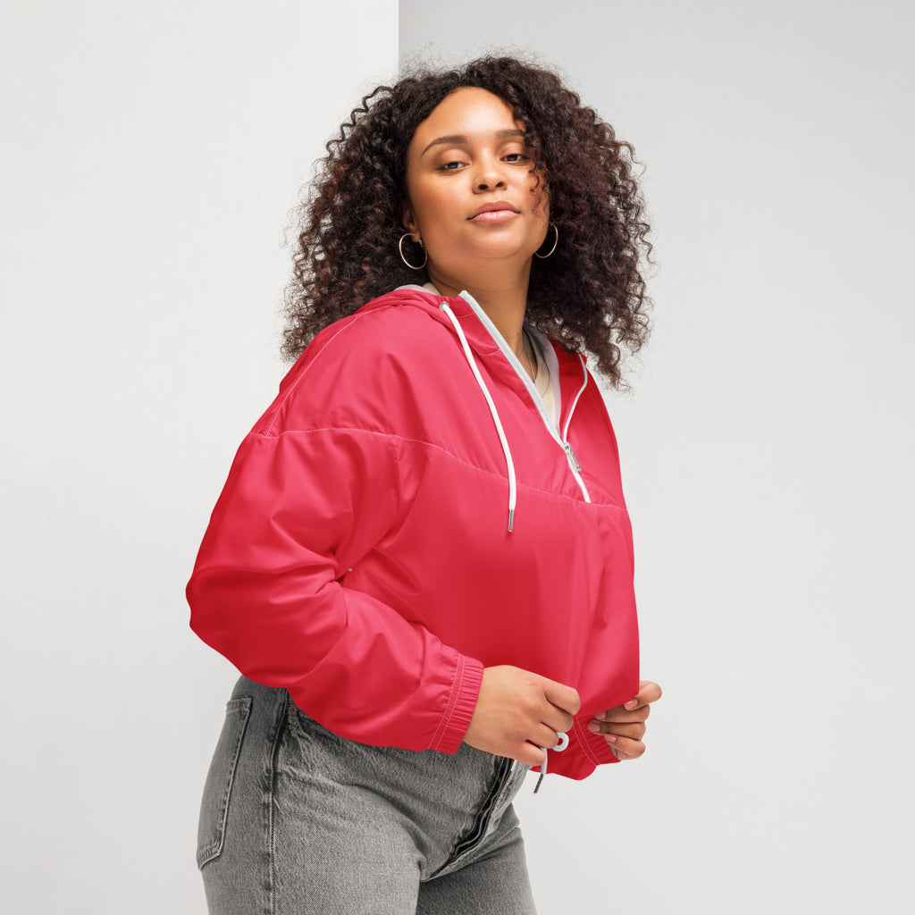 Women’s bright pink cropped windbreaker featuring a vibrant red puffer-style hooded jacket with white drawstrings and zipper accents